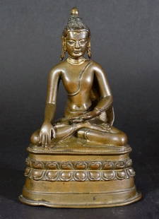 Rare Western Tibet Bronze Buddha: On double lotus base with a rich brown patina. Yuan-Ming period, 13/14th century. Measures 7.25" in height.