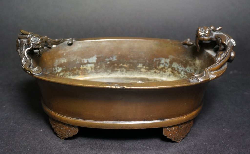 Chinese Oval Shaped Bronze Censer: With two dragons, Xuande mark. 18th century. Measures 8" in wide.