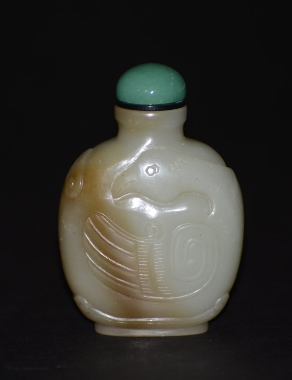 Chinese Celadon Jade Snuff Bottle: Chinese celadon jade snuff bottle of archaic style duck of a splash russet brown tone. Measures 3.75"h