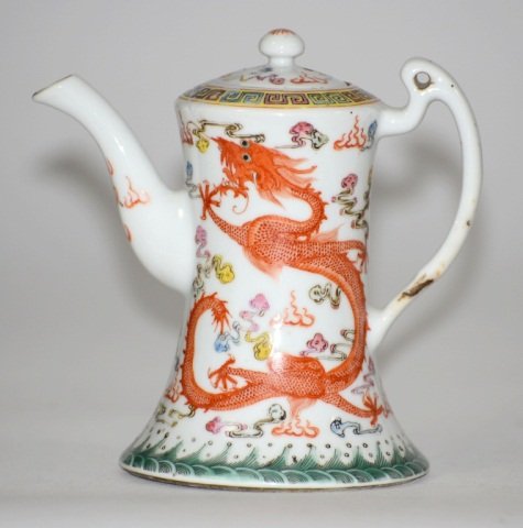 Chinese Famille Rose Porcelain Teapot: Chinese famille rose porcelain teapot of iron red glazed dragon motif, 19/20th cen . Measures 6"h by 6"w. Guangxu Mark.