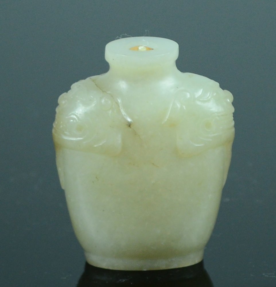 Chinese Carved Jade Snuff Bottle: celadon with foolion mask design on shoulders, 19th cen, 2"h Please visit our website http://stallionhillgallery.com/ to see the high resolution photos. Thanks! 欲见高清照