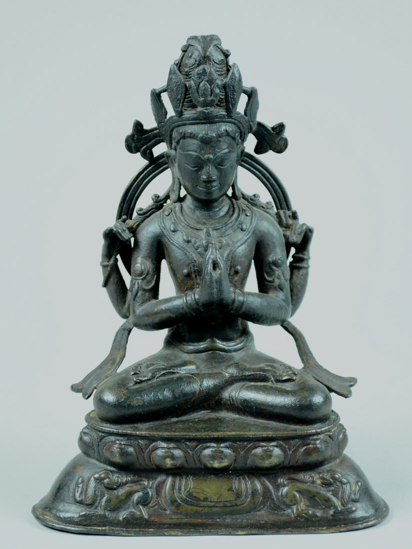 Early Tibetan Bronze Seated Kuanyin: Four arm, seated on double lotus base with attendant Buddhist lion. 14/15th cen, Western Tibet. measures 7.2"h 5.4"w Provenance: from a New York estate Please visit our website http://stallionhillgall