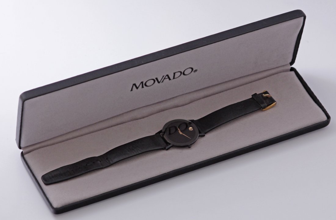 Vintage Movado Museum Classic Wristwatch: Vintage Movado Museum Wristwatch classic black face with gold marker at 12 and gold hands in black case original band serial# 87-40-882N 1152584 Quartz movement in original box Size - 32mm width inclu