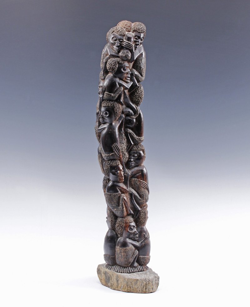 African Tribal Spiritual Totem Pole Sculpture: Vintage Exotic wood African Tribal Spiritual Pole Carved Sculpture with figures closely interwoven embracing in fetal positions deep patina on rough rock base Size - 26" x 9 1/2" x 5"