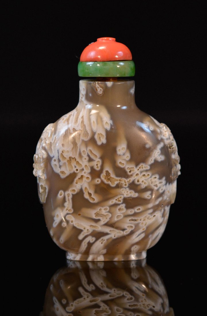 Chinese Agate Snuff Bottle: speckled with foolion mask handle, measures 2.75"h