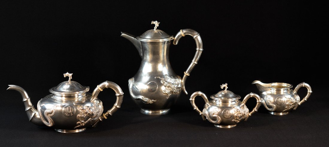 Four Pieces Chinese Export Silver Tea Set: 19th cen, dragon motif, bottom stamp: CJ; largest piece measures 9.5"h, 8.5"w .