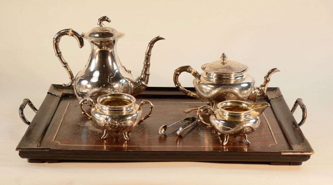 Set of Chinese Export Silver Tea Set with Unique Tray: 19th cen, dragon motif, rosewood tray with inlayed design, largest piece measures 9.5"h 10"w, tray measures 22" by 16"; Provenance: from a Long Island Collection