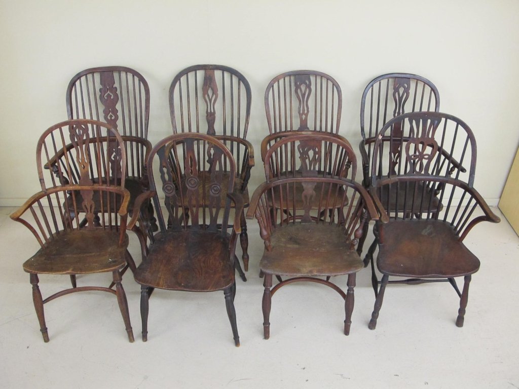 eight early English Windsor armchairs: A collection of eight English Windsor armchairs, 1760-1800. All with carved saddle seats, hoop backs and various style stretcher arrangements, all with old color and surface. Elm, walnut, etc., most a