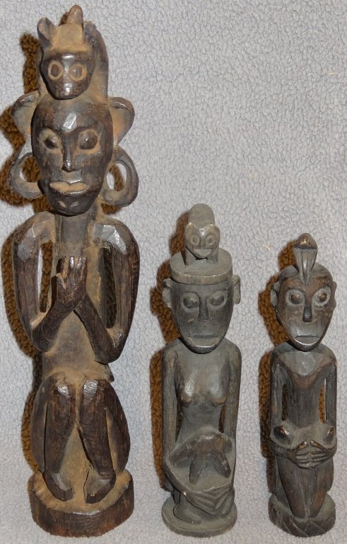 Three Indonesian tribal carvings: Three Indonesian tribal carvings, Karo Batak , North Sumatra 19C. Of carved hard wood of modest size, exceptional examples, a male and female pair, with animal surmounted crowns, and a larger Shaman f