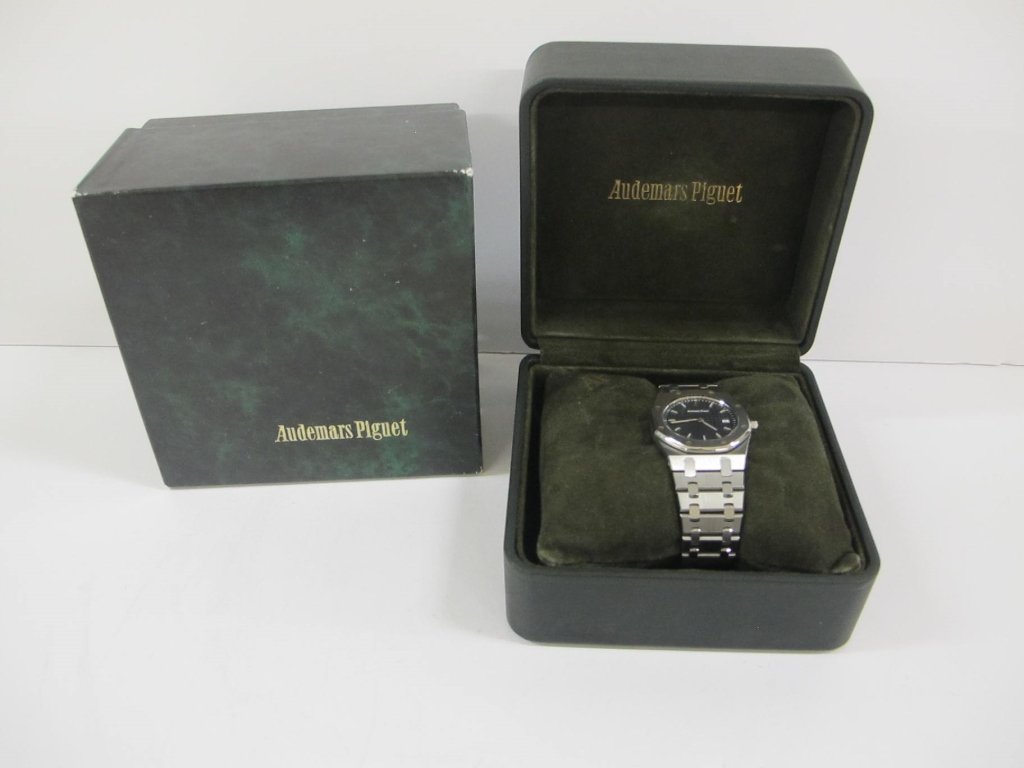 Audemars Piguet watch: Audemars Piguet watch in original box with paperwork. Some wear to box.