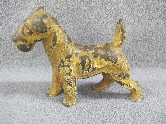 Antique dog doorstop: Antique dog doorstop. Cast iron painted dog. 7" high.