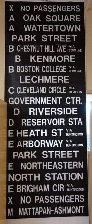 MBTA Boston sign shop uncut rolling train/bus sign: Large MBTA Boston uncut rolling train/bus stop sign. Small pin holes; stains. 14 ft. long x 50 inches wide.