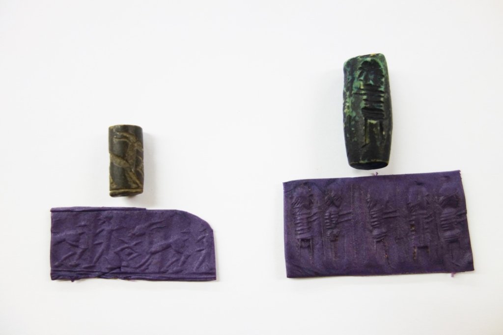 2 Middle Eastern archaic cylinder seals: 2 Middle Eastern archaic cylinder seals (probably Sumarian). An ancient free standing Middle Eastern cylinder seal of mottled green stone. Particularly archaic, undrilled- apparently used as hand roll