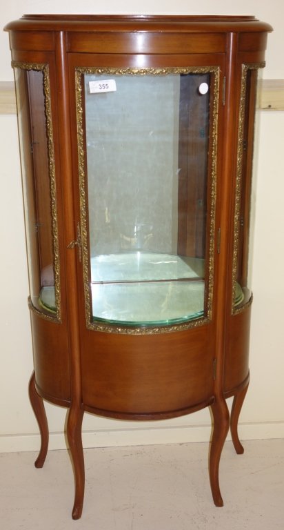 French style glass curio cabinet: French style glass rounded front curio cabinet. 56 inches x 27 inches x 13 inches.