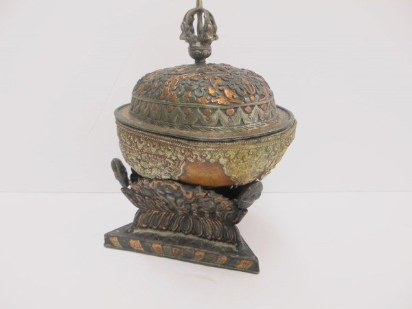 Tibetan early ceremonial scull box: Tibetan early ceremonial scull box. From a Monks cranium, silver, copper, and bone ceremonial vessel. The skull probably much older than the fittings, with a few jewels. 9 1/2 inches high x 6 1/2 inch