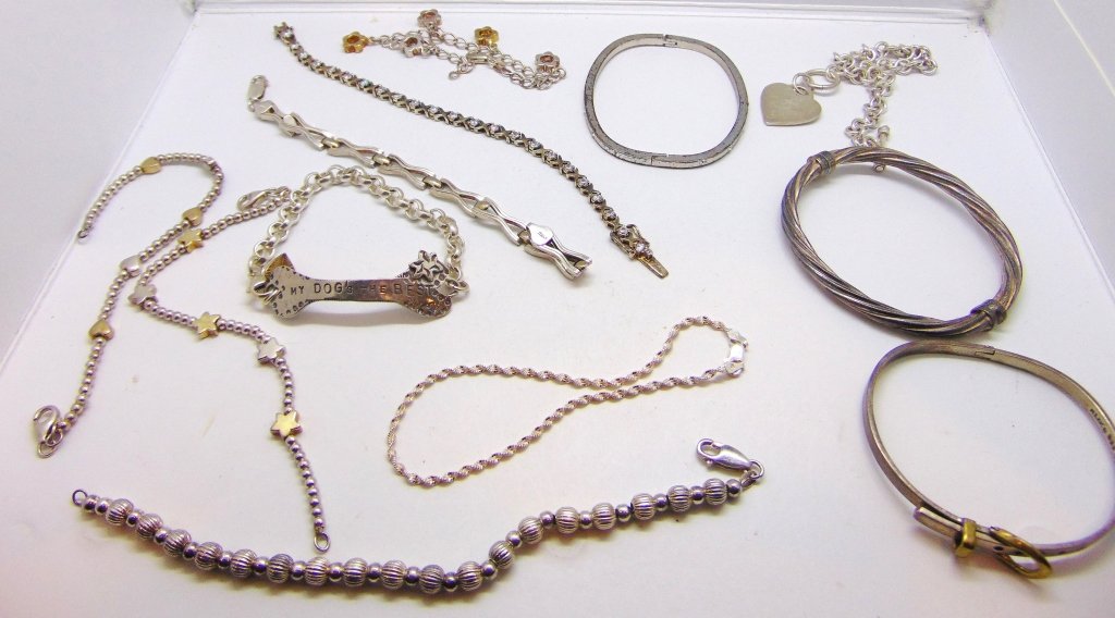 Sterling silver bracelet lot: Sterling silver bracelet lot consisting of 9 sterling silver link bracelets & 3 sterling silver bangle bracelets. 4.6 ozt