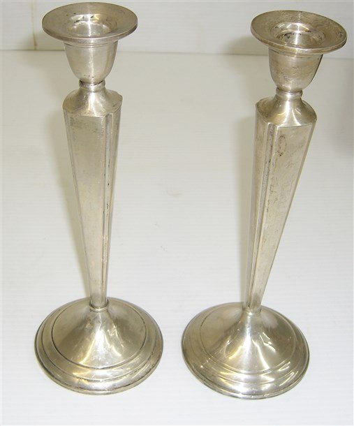 Pair of silver weighted candle holders: Pair of silver weighted candle holders. 10 1/2 inches high x 4 inches wide.
