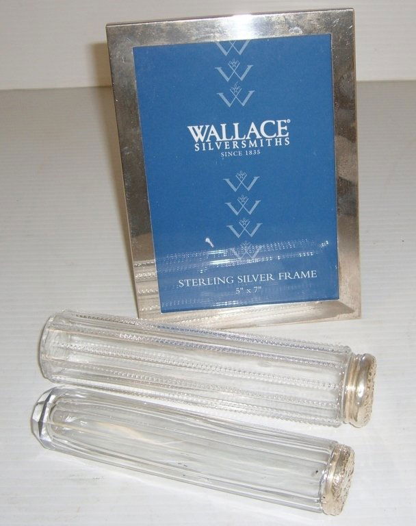 3 pc. sterling silver frame & 2 dresser jars: 3 pc. lot including Wallace Silversmiths sterling silver frame & 2 glass with silver top dresser jars. Largest measures 5 inches x 7 inches.