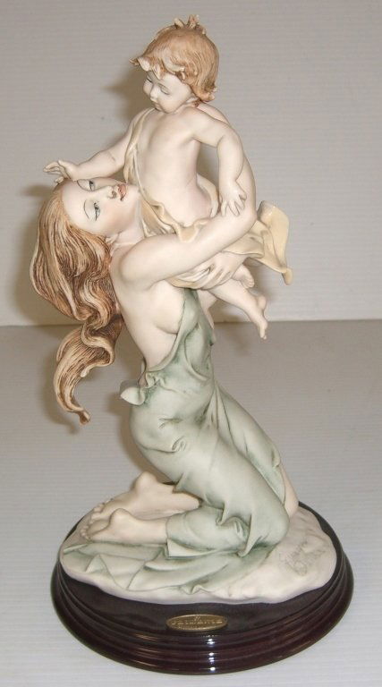 Capodimonte woman statue by Giuseppit Armani: Capodimonte mother & child statue by Giuseppi Armani. Chips on child's hair. 13 inches high x 7 inches wide.