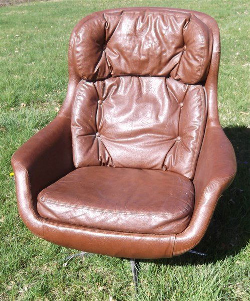Mid-century modern Brown leather lounge chair: Mid-century modern brown leather egg shaped swivel rocker lounge chair by Selig Imperial. Some paint flecks, black piece on bottom missing; no tear, no rips; some wear. 39 inches high x 29 inches wide