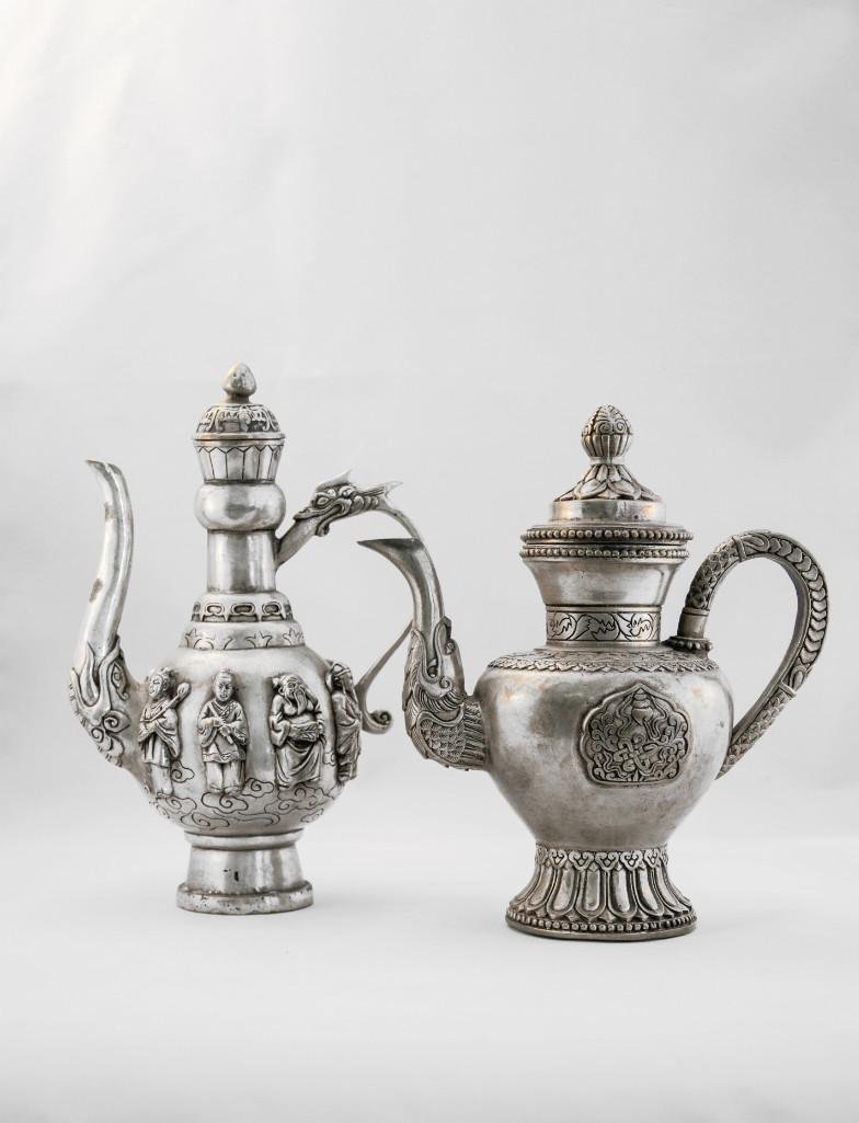 TWO CHINESE SILVER EWER WITH COVER: Silver ewer of Eight Immortals with bat repossed cover with dragon head handle, four character Qianlong mark on base. Height: 9in (23cm). second, rich repoussed, engraved and chased on the body o