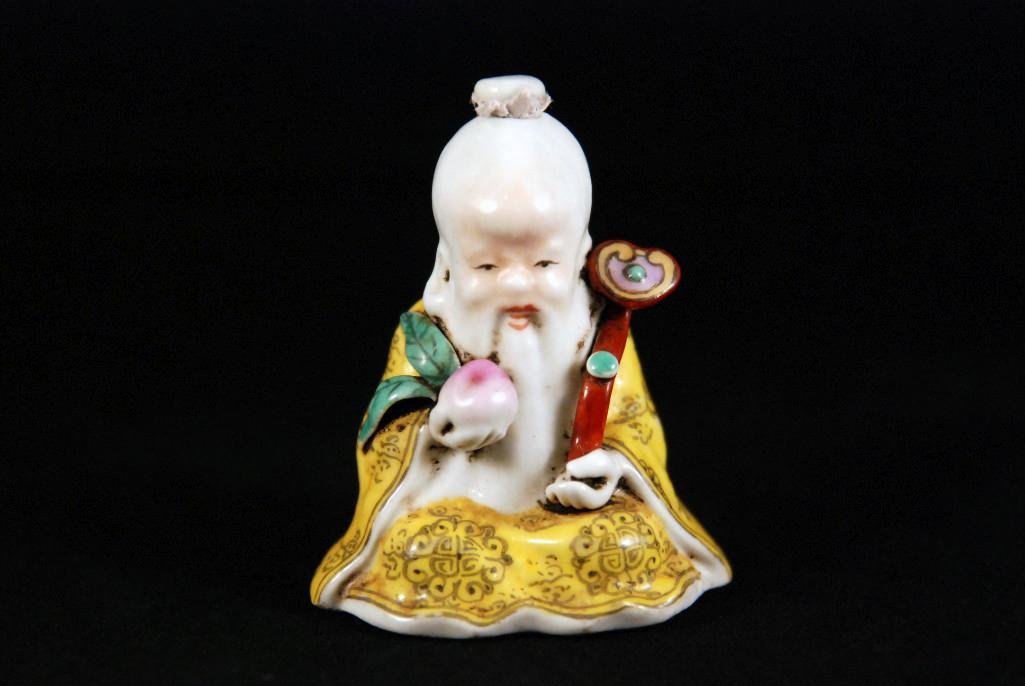 SEATED SNUFF BOTTLE OF SHUOLAO: Resting an arm holds a ruyi scepter in his left hand while holding peaches on right, four character GuangXu marked on base. Height: 2 5/8in (6.5cm).