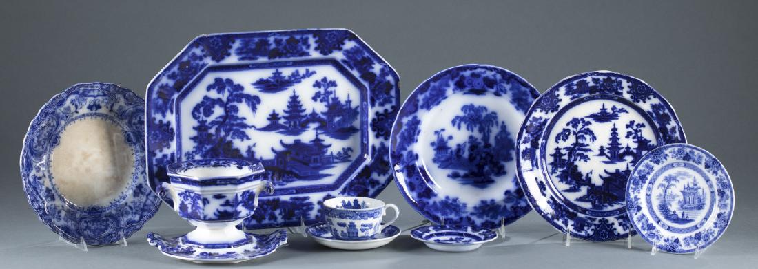 Flow Blue Ironstone Collection.: W. Adams & Sons "Tonquin" flow blue ironstone. Stamped on base. To include: waste bowl with base + two saucers + large platter with chip to rim + two dinner plates ++ Scinde blue flow ironstone in wil