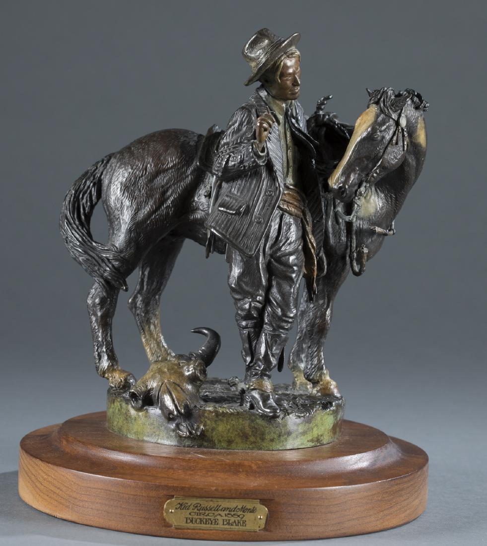 Buckeye Blake (United States, b.1946) Bronze.: Buckeye Blake (United States, b.1946). "Kid Russell and Monte circa 1889" bronze on wooden base, c.1986. Edition 92/100. Signed on base. 12 1/2" h x 10 1/2" diam.