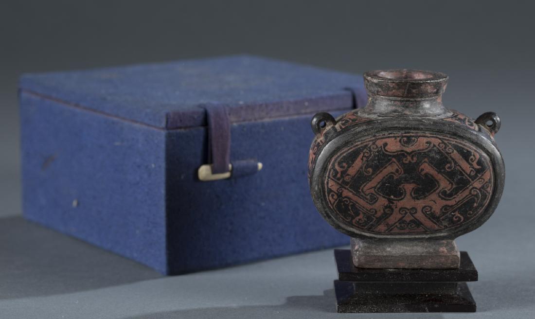 Chinese Red & Black Lacquered Two-Handled Vessel.: A Chinese red & black lacquer painted over pottery base two-handled vessel. Han Dynasty style. Possibly an incense holder. Major wear from age and use. Deascessioned from the Pan Asian Collection. Mus