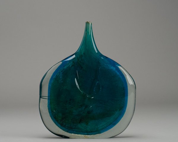 Mdina Art Glass Fish Head Vase of Heavy Turquoise : Mdina Art Glass Fish Head Vase of Heavy Turquoise and Clear Cased Glass. Remnants of adhesive residue on base over Michael Harris Mdina Glass Malta inscribed signature. 11 1/2" H x 9 1/2" W x 1 1/2" D