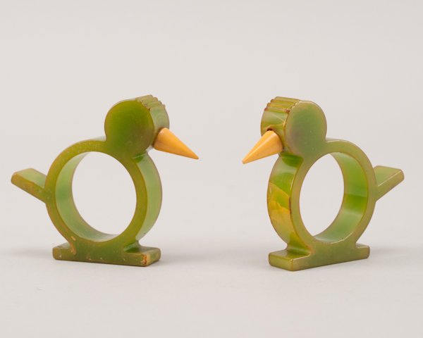 A Pair of Bakelite Figural Bird Napkin Rings.: A Pair of Bakelite Figural Bird Napkin Rings. Light scratching and slight damage to one beak. Each 2 1/2" H x 3" W x 1/2" D.