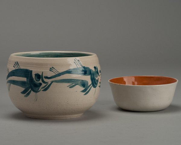 A Manitoulin Island Pottery Bowl and an Orange and: A Manitoulin Island Pottery Bowl and an Orange and Cream Studio Pottery Bowl. Manitoulin bowl with glazed fish design and marked "Manitoulin Island / Island Pottery" on base. Manitoulin Island is loca