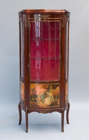 An ormolu mounted and painted mahogany vitrine.: In the manner of Verni Martin, with a red damask lined interior and glass shelves. 59 1/2"h x 27"w x 14 1/2"d.
