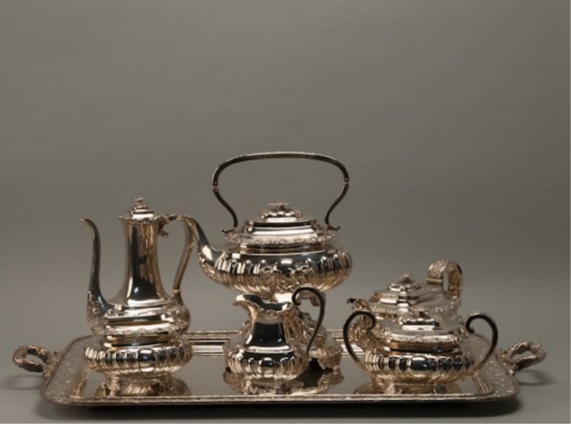 A seven-piece Gorham coffee & tea service.: Six sterling pieces to include: a coffee pot, teapot, hot water kettle on stand, all with hinged lids and ivory spacers, the stand with hinged lid to the burner, a lidded sugar bowl, creamer and waste