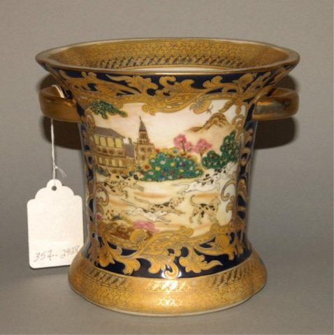 An Asian Porcelain Cachepot: with gilt overlay decoration on blue ground and cartouches of dogs running a landscape.