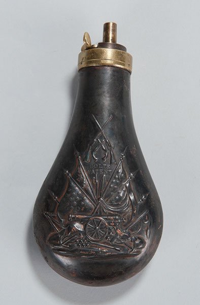 Copper Powder Flask 7' Overall Length With Panoply: Copper Powder Flask 7" Overall Length With Panoply Of Arms On One Side And Cannon And Cannon Balls At Bottom. Between Flags At Top Is "Colts Patent." Reverse Side Near Top Stamped "Made In England" Ov