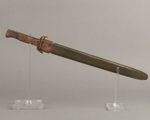 American M-1 rifle bayonet scabbard with accompanyi: American M-1 rifle bayonet scabbard with accompanying WWII German bayonet. Both in fair condition.