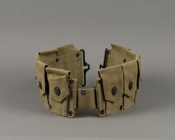 World War II about mint condition M-1 rifle cartrid: World War II about mint condition M-1 rifle cartridge clip belt boldly marked “US” and bearing “1943” manufacture date over maker’s mark “HS CO.”