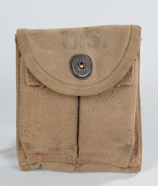 World War II US Army M-1 Carbine canvas clip pouch: World War II US Army M-1 Carbine canvas clip pouch complete with two carbine clips. Maker marked and dated 1943.