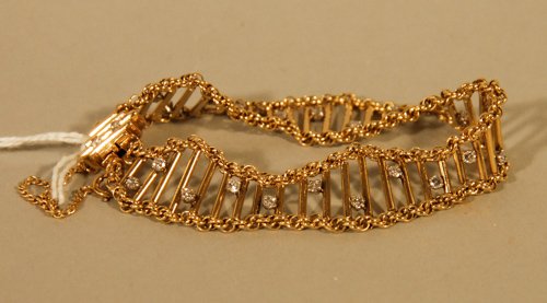 A 14K Yellow Gold and Diamond Bracelet: A 14K Yellow Gold and Diamond Bracelet Contains 25 Full Cut Melee Diamonds Set on a Contemporary mount of Multiple Vertical Bars Set in an Undulating Perimeter of Rope Chain Design, 13.1 dwt.