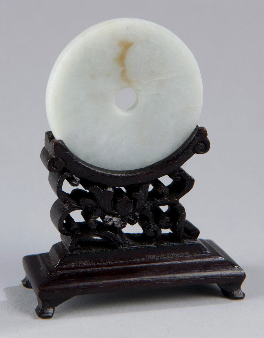 Carved White Jade Bi Disc with Carved Stand: Carved White Jade Bi Disc with Carved Stand Fish and bat carving with floral carving on verso. Disc: 2"" Dia, Stand: 2"" x 2 3/4""