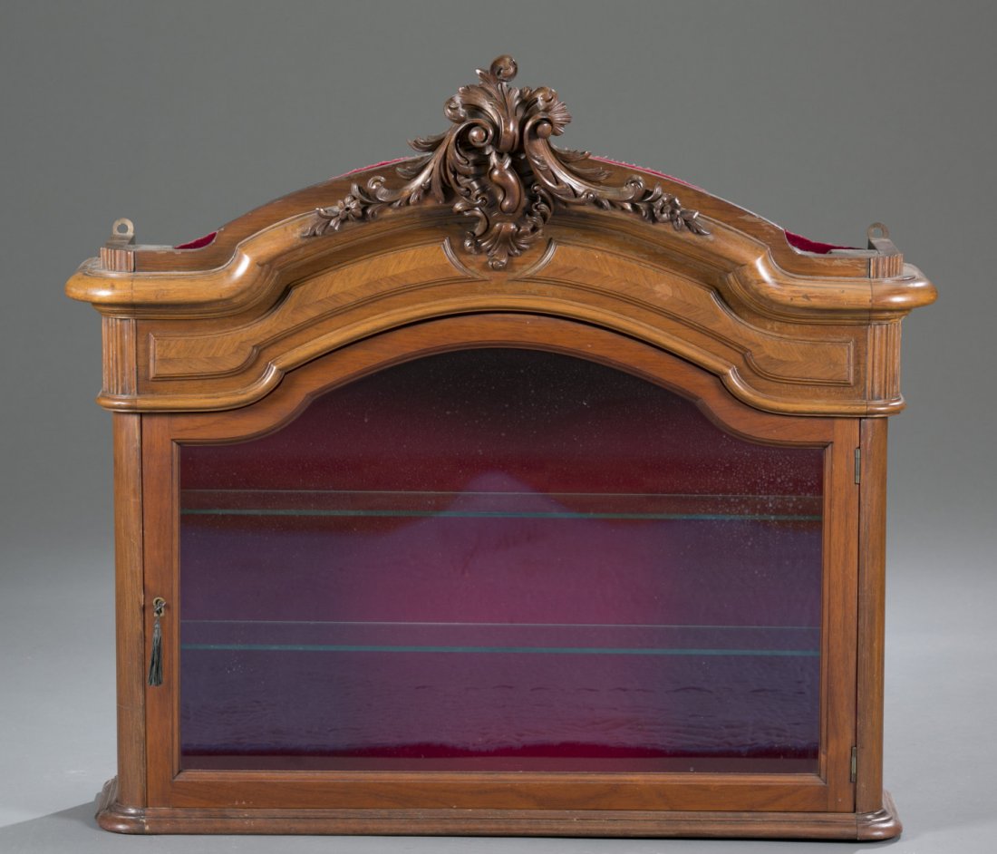 Wall Hanging Curio Cabinet: Wall Hanging Curio Cabinet Electrified wall hanging curio cabinet with decorative carving at the top. Inside is lined with red velvet and there are two glass shelves for displaying items. 34"" H x 32"