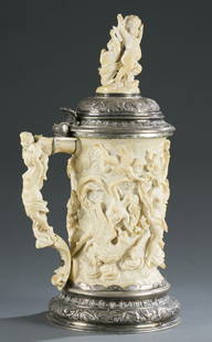 German Carved Ivory and Silver Gilt Mounted Tankard: German Carved Ivory and Silver Gilt Mounted Tankard 19th Century, High relief carving on body, finial and handle with putti, nudes and a chariot. 16"" H