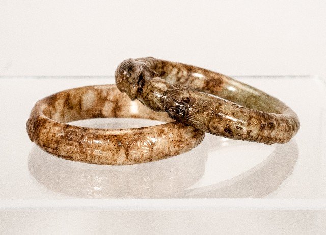 Two (2) Jade Bangles: Two (2) Jade Bangles To include (two pieces): Earth toned bangles. Carved with asian symbols and reptiles. 3 1/2"" D