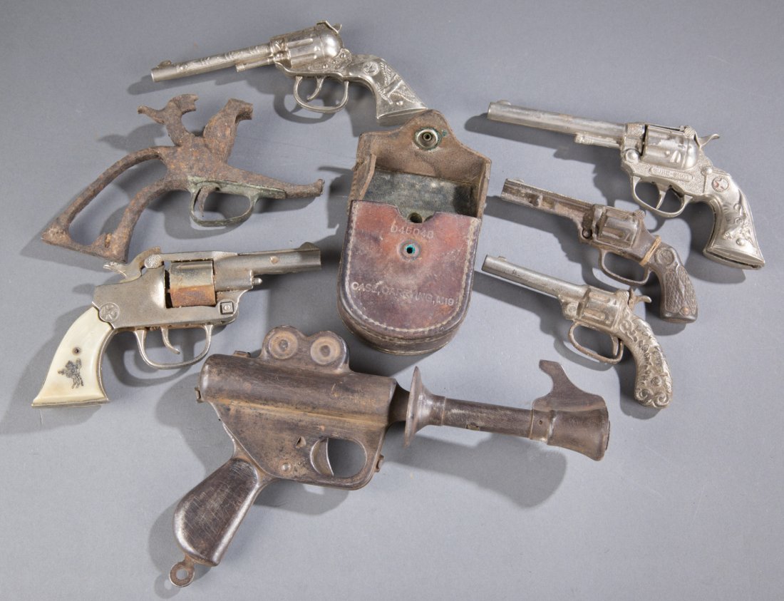 Assortment of Seven (7) Hand Guns and One (1) Compass: Assortment of Seven (7) Hand Guns and One (1) Compass Includes: one (1) M2 compass with leather holder labeled, ""The Kalart company inc. Stamford, Conn."", seven (7) toy hand guns including but not l