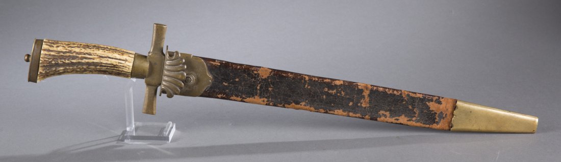 Ca. 1870 German Hunting Cutlass: Ca. 1870 German Hunting Cutlass German hunting cutlass with brass mounted leather scabbard ca. 1870. (with scabbard) 22 3/4'' L x 2'' W (at hilt)