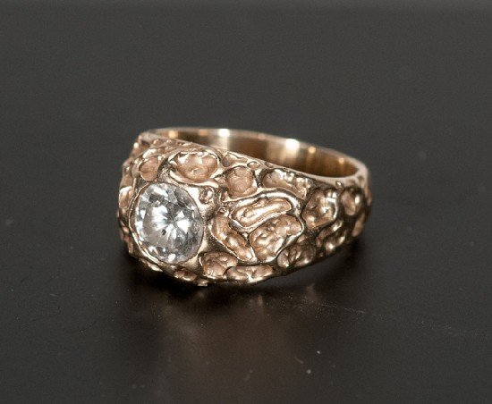 Solitaire Diamond and 14K Gold Ring: Solitaire Diamond and 14K Gold Ring Containing approx. .87 ct. round brilliant cut diamond with I clarity and H-I color. Set in nugget style 14K yellow gold ring. Accompanied by an appraisal.