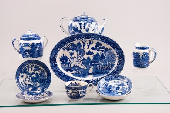 Blue Willow Pieces: Blue Willow Pieces To include (11 pieces): Platter, lidded teapot, Japan, Cup with saucer, 2 Ridgway saucers, Wedgwood sugar and creamer. 12"" L x 9"" W