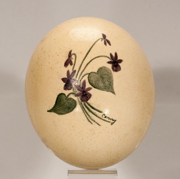 Painted Ostrich Egg: Painted Ostrich Egg One (1) ostrich egg with green and purple painted floral design. Signed, ""Conny"", at lower right of design. No cracks. 5"" Dia