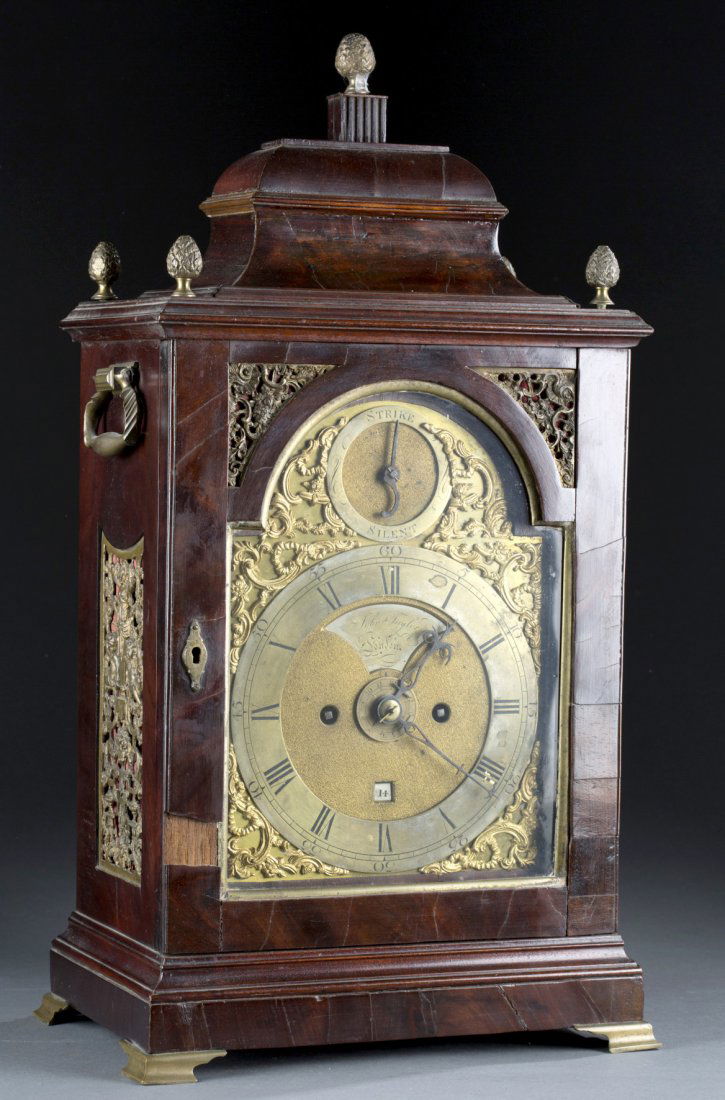 Georgian Mahogany Veneer Mantle Clock: Georgian Mahogany Veneer Mantle Clock Brass face with Roman numerals marked, "John Taylor London." Brass movement with incised floral ornamentation. Some veneer loss. 20 1/4" H x 10 3/4" W x 7 1/4" D
